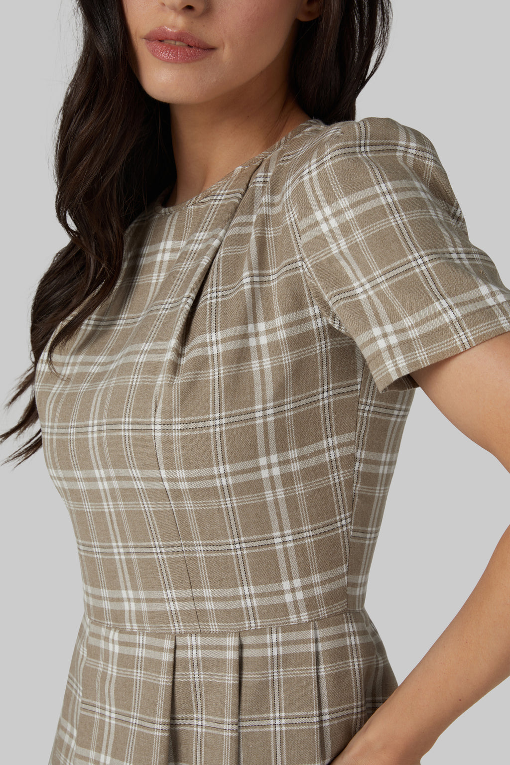 brown dress with a pleated neckline 