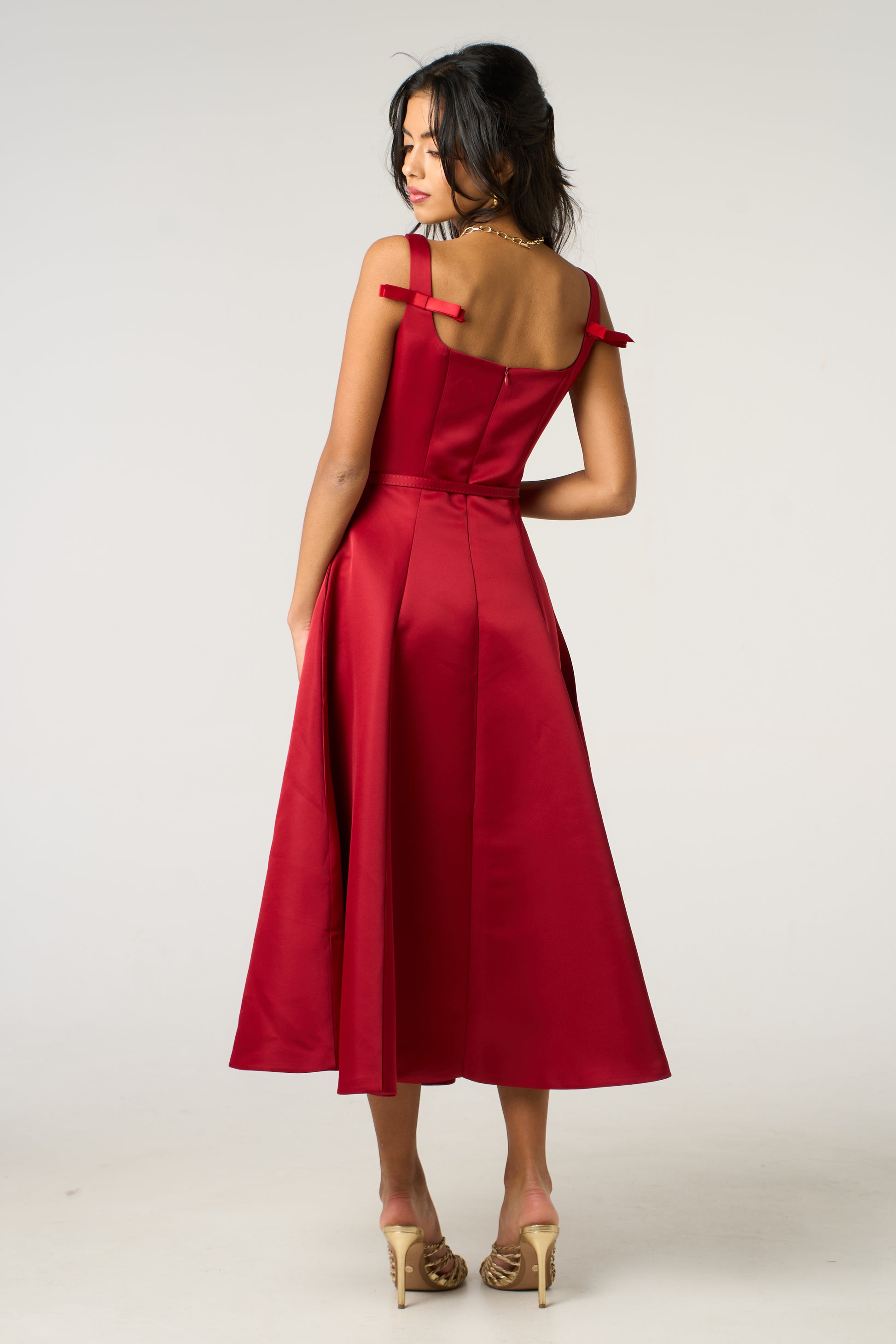 Woman wearing a red dress with a white background